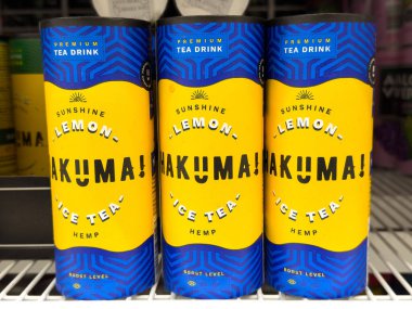 Hakuma sunshine lemon ice tea with hemp in vibrant blue and yellow cans. clipart