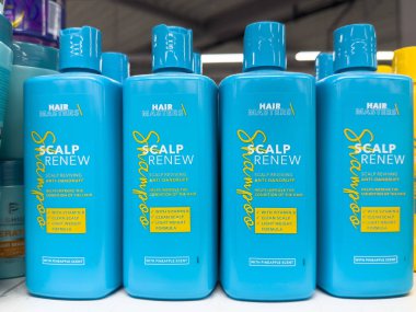 Scalp reviving anti-dandruff shampoo bottles with pineapple scent in store display. clipart