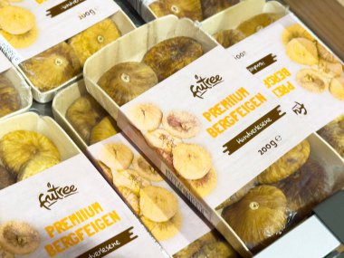 Packaging of premium dried figs with natural label design in retail display. clipart