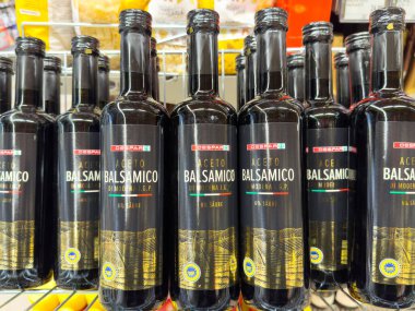 Süpermarket rafında İtalyan balzamik sirkesi şişeleri.
