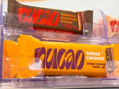 Nucao chocolate bars display with roasted hazelnut and salted caramel flavors. clipart