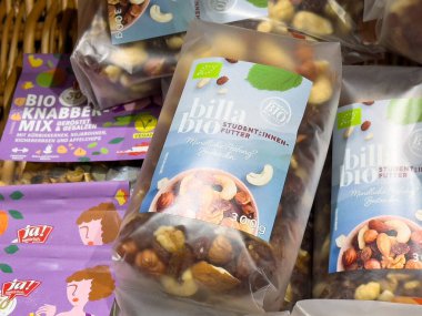 Market vitrininde vegan ve çevre dostu etiketlerle organik fındık karışımı paketleme.