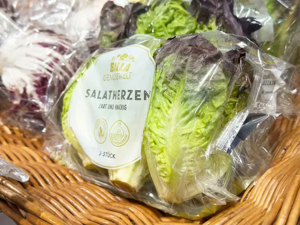 Market vitrininde hasır sepette paketlenmiş marul başları.