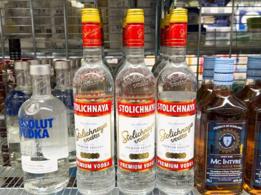 Bir mağazanın rafında sergilenen kaliteli votka şişeleri, tüketiciler için mevcut çeşitli seçenekleri, içecek seçimi konseptini vurguluyor