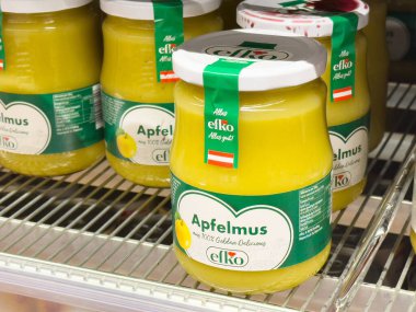 Rafta yeşil etiketli ve beyaz kapaklı apfelmus elma püresi var..