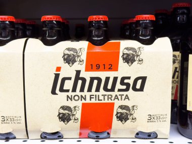 Ichnusa non filtrata bira şişeleri etiket tasarımı ile mağaza rafında.