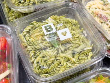 Depoda sergilenen plastik kapta pesto ile paketlenmiş taze fusilli makarna..