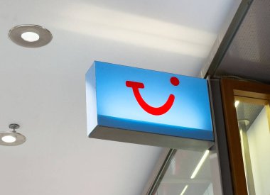 Mağaza vitrininde Tui logosu işareti: modern tasarım ve markalaşma.