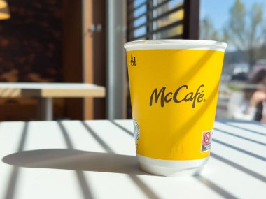 Sıcak kafe ortamında, güneş ışığında kahve fincanı..