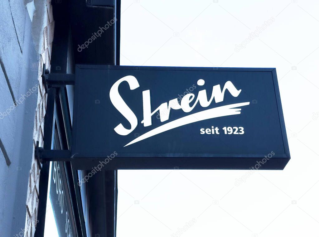 Strein storefront signage against clear sky.