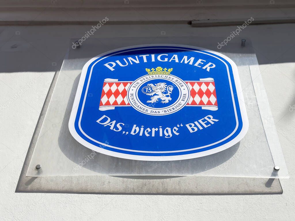 Puntigamer beer sign with blue and red logo displayed on wall.