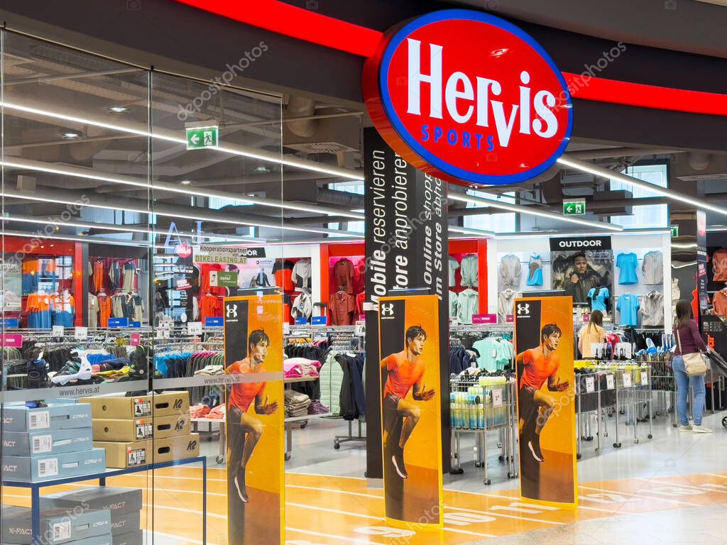 Hervis sports store interior featuring clothing equipment displays with modern design.