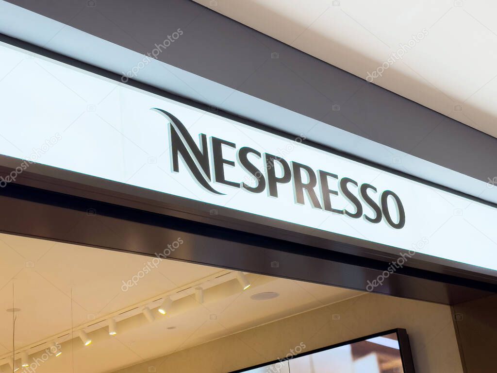 Nespresso storefront signage with modern design.