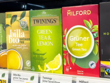 Villach, Avusturya - 17 Nisan 2025: Rafta yeşil çay paketleri sergilenmesi çay severlerin keşfetmesi için çeşitli marka ve tatları ön plana çıkarıyor