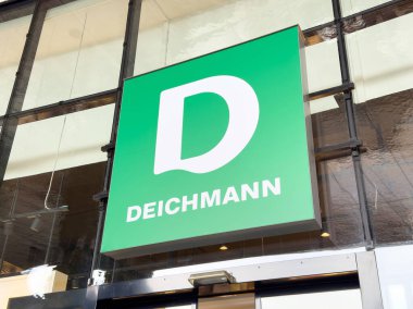 Villach, Avusturya - 17 Nisan 2025: Perakende markalaşma kavramı, bir ayakkabı mağazası markasını temsil eden cesur bir D harfinin yer aldığı çarpıcı yeşil bir işareti vurguluyor