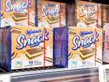 Villach, Avusturya - 17 Nisan 2025: Bir mağazada düzenlenen abur cubur ambalajı lezzetli ikramlar arayanlar için çeşitliliği ve kolaylığı ön plana çıkarıyor