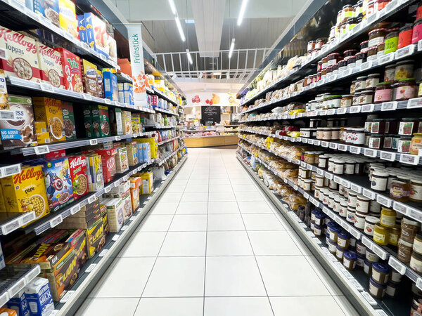 Villach, Austria - April 17, 2025: Grocery store aisle displays a wide range of food items, highlighting the importance of variety and accessibility in nutrition