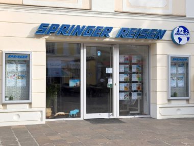 Avrupa caddesinde turizm posterleri ve cam kapıları olan bir seyahat acentası..