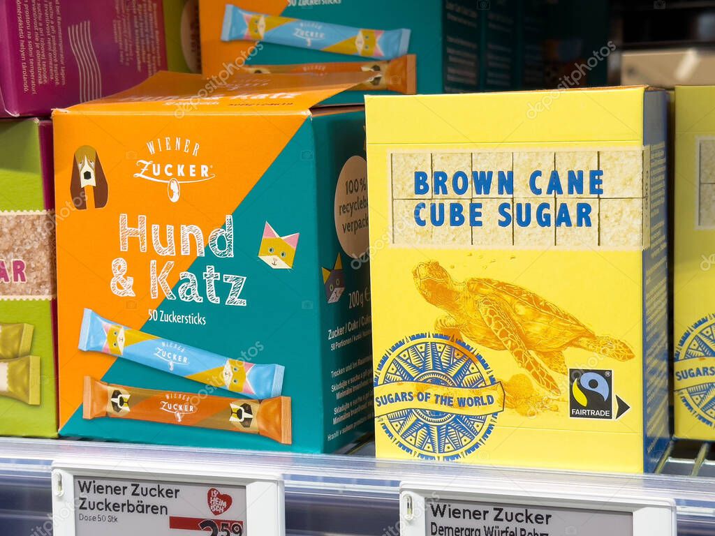Colorful animal-themed candy and brown cane cube sugar packaging display.