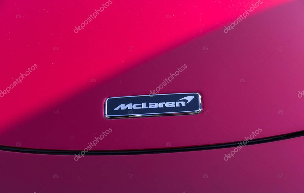 Velden, Austria - June 22, 2024: McLaren emblem displayed on red sports car at Sportwagenfestival, highlighting luxury and performance in automotive design