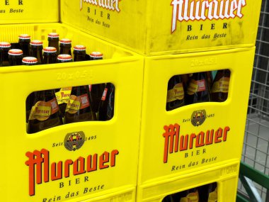 Villach, Avusturya - 06 Mayıs 2025: Murauer Bier 'in sarı sandıkları, ikonik marka ve şişeleri sergiliyor ve canlı bir perakende atmosfer yaratıyor.