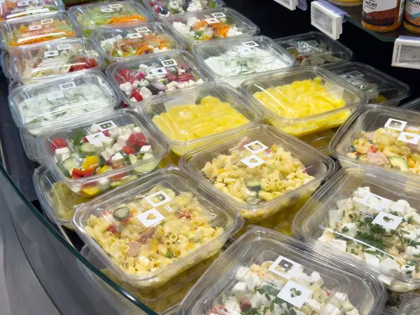 Taze paketli salata çeşitleri ve market vitrininde yemekler.