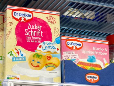 Renkli Dr. Oetker raflarda krema ve fırın malzemeleri dekore ediyor..