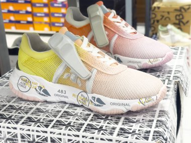 Siyah ve beyaz geometrik yüzeyde depolanan renkli spor ayakkabıları.