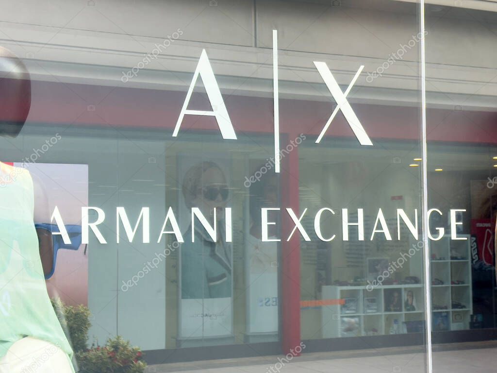 Armani exchange storefront with reflective glass display.