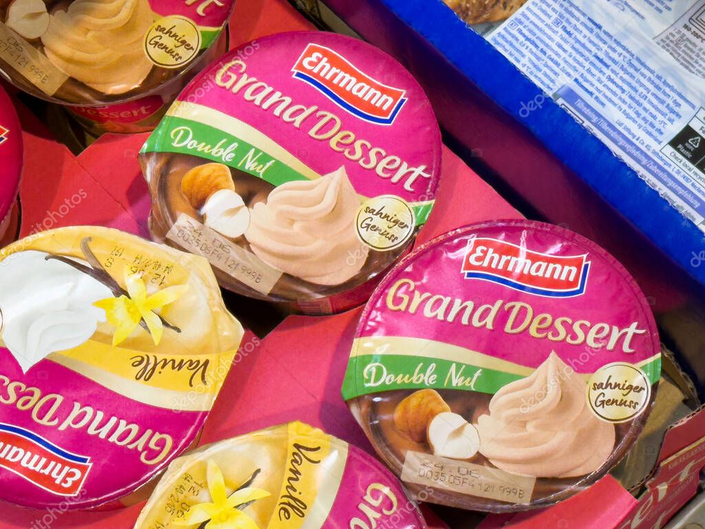 Assorted ehrmann grand dessert varieties in supermarket display.