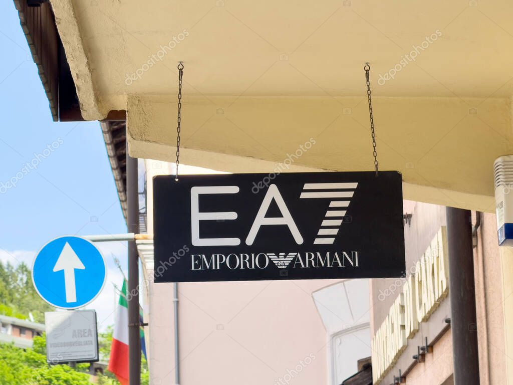 Ea7 emporio armani store sign hanging outside urban building.