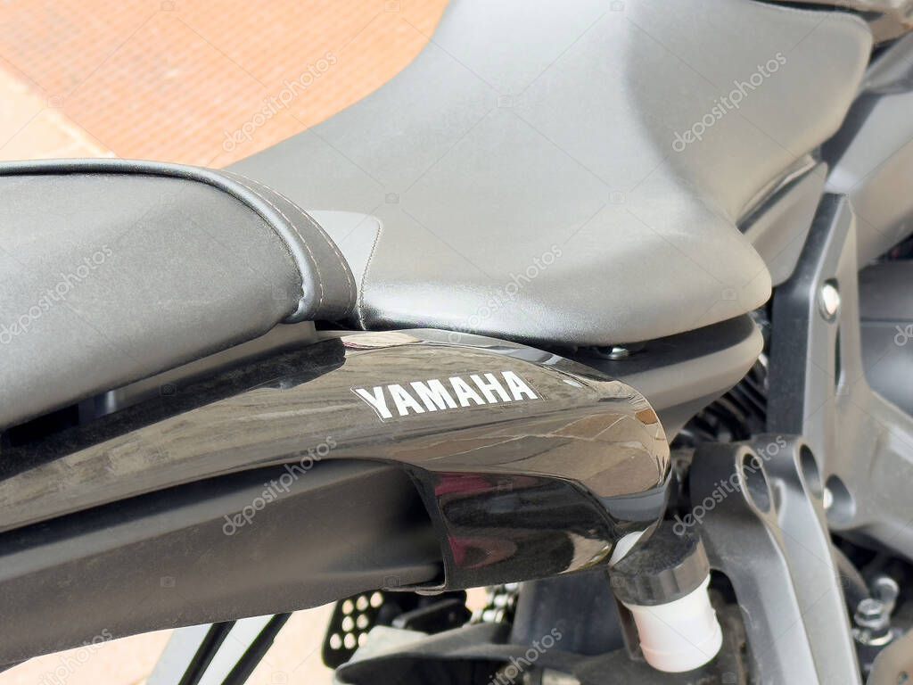 Yamaha motorcycle close-up featuring black seat and rear body design.
