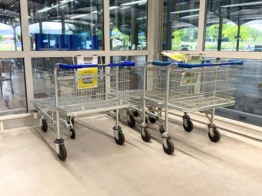 Girişteki bakkal otoparkında iki boş alışveriş arabası..