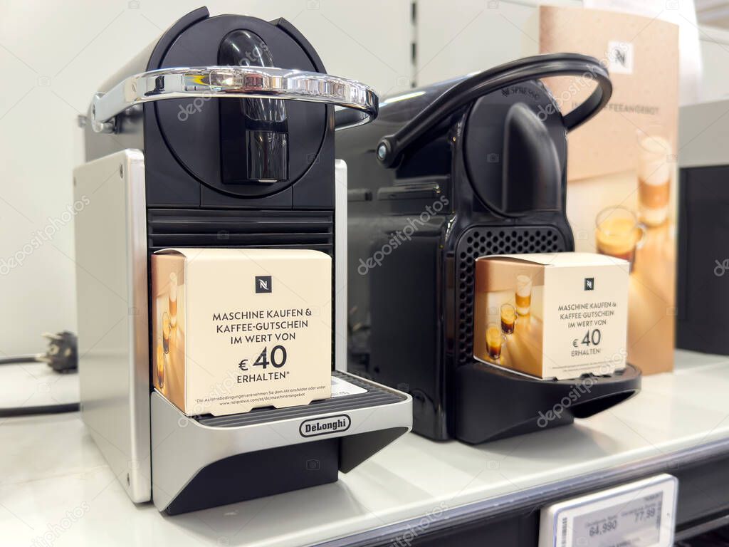 Delonghi nespresso machines with gift voucher display on store shelf.