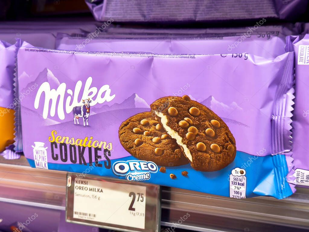 Milka sensations oreo creme cookies on store shelf.