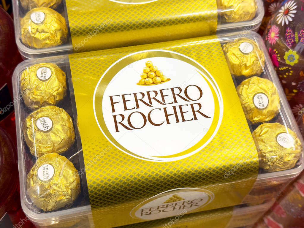 Ferrero rocher chocolate box with wrapped hazelnut confections in gold packaging.