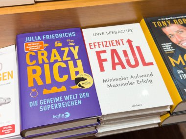 Villach, Avusturya - 01 Temmuz 2025: Bir kitapçıdaki ahşap rafta 
