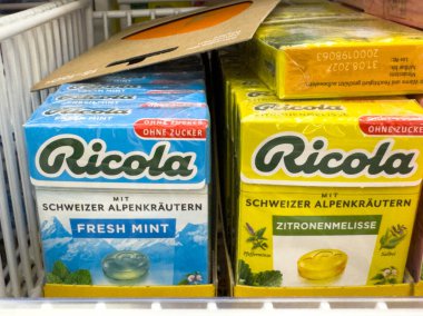 Villach, Avusturya - 28 Temmuz 2025: Renkli ambalaj ve ürün çeşitliliğini vurgulayan taze nane ve limon aromalı Ricola şeker kutuları