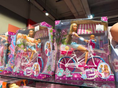 Villach, Avusturya - 30 Temmuz 2025: Canlı bir mağaza ortamında bisiklet süren, eğlenceli Bisiklet Turu temasını vurgulayan, parlak renkli oyuncak kutular Steffi oyuncakları sergileniyor