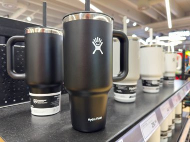 Villach, Avusturya - 18 Ağustos 2025: Saman ile Hydro Flask bardağı perakende saman sahasında belirgin bir şekilde ön plana çıkarak, şık tasarımı ve işlevselliğini ön plana çıkarıyor