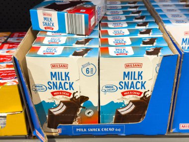 Villach, Avusturya - 21 Ağustos 2025: Milsani süt paketleri bir süpermarket rafına yerleştirilmiş, çikolata aromalı ve canlı ambalajlı