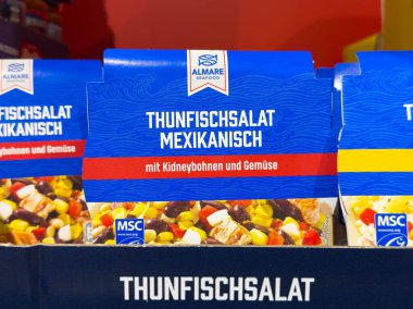 Villach, Avusturya - 21 Ağustos 2025: Almare Seafood ton balığı salatası paketleri renkli malzemelerin ve çekici markaların altını çizerek bir rafa dizildi