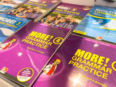 Villach, Avusturya - 17 Eylül 2025: Öğrenciler için canlı kapaklar ve çeşitli konular içeren İngilizce eğitim kitapları bir masanın üzerinde düzenlenmiştir