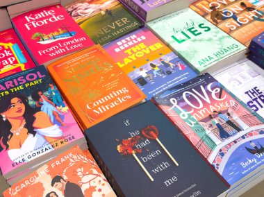 Villach, Austria - September 28, 2025: Vibrant assortment of novels on display, featuring various book covers and artistic designs, ideal for readers and literature fans