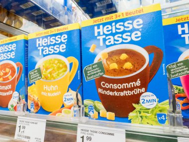 Villach, Austria - September 28, 2025: Heisse Tasse soup packages are neatly arranged on a supermarket shelf, showcasing various flavors and bright packaging