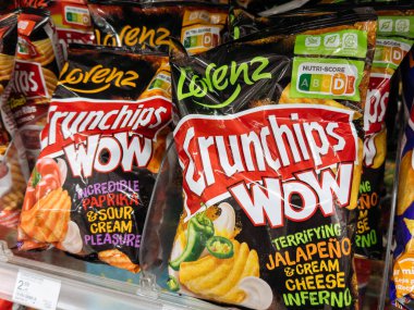Villach, Austria - September 28, 2025: Lorenz Crunchips Wow snack bags displayed on supermarket shelf, featuring paprika and sour cream flavors with colorful packaging