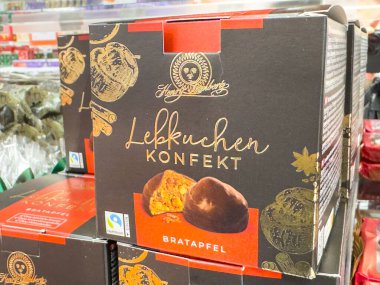 Villach, Austria - September 28, 2025: Lebkuchen Konfekt Bratapfel box in grocery store, highlighting traditional German gingerbread with colorful packaging
