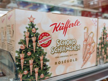Villach, Austria - September 28, 2025: Kufferle Schoko Schirmchen chocolate cones box on shelf, featuring festive design and holiday-themed elements