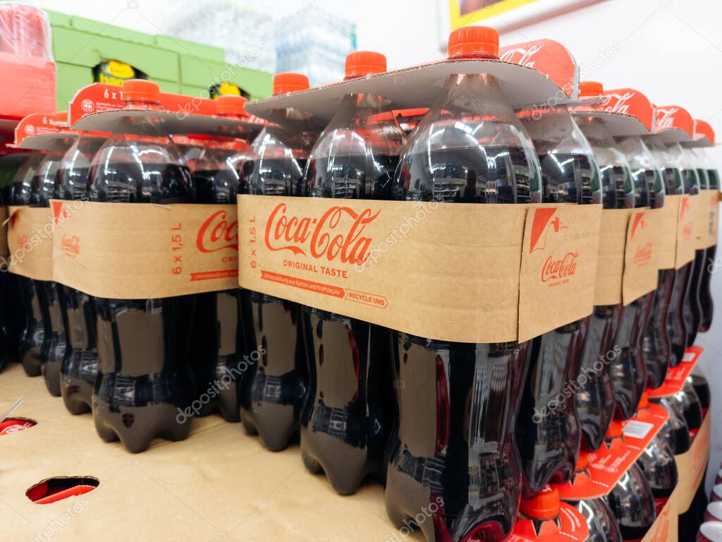 Villach, Austria - September 28, 2025: Coca-Cola bottles arranged in a retail setting, highlighting the brand's classic design and appealing colors
