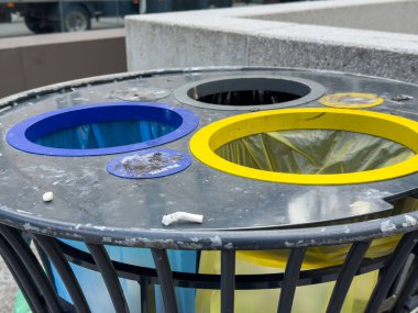 Ljubljana, Slovenia - October 02, 2025: Colorful recycling bins are placed in an urban area, promoting waste separation and environmental awareness